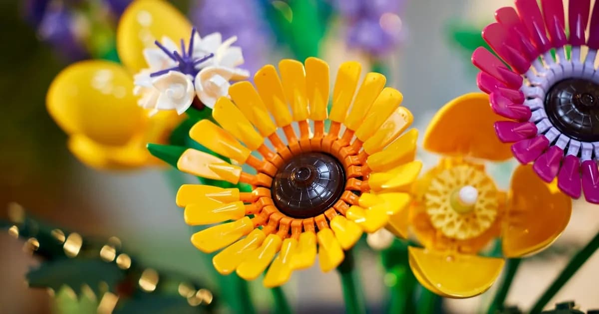 Close-up of the LEGO Wildflower Bouquet 10313: a yellow brick-built sunflower beside pink, purple and orange flowers