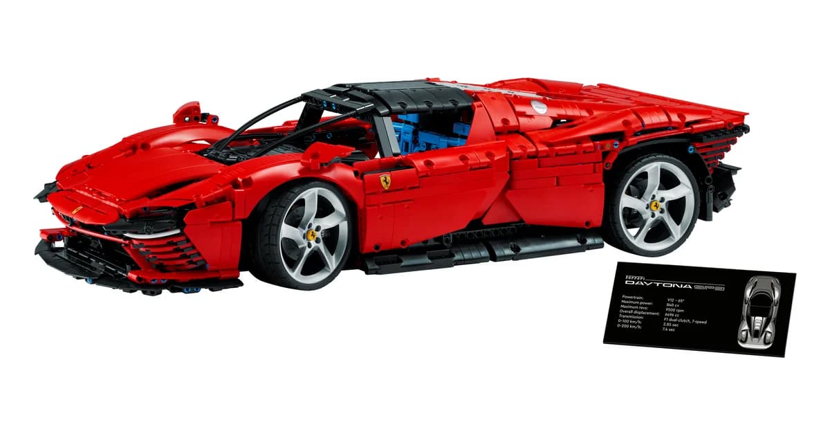 LEGO Technic Ferrari Daytona SP3 42143, a red 1:8 scale supercar model with butterfly doors and chrome rims beside its black display plaque