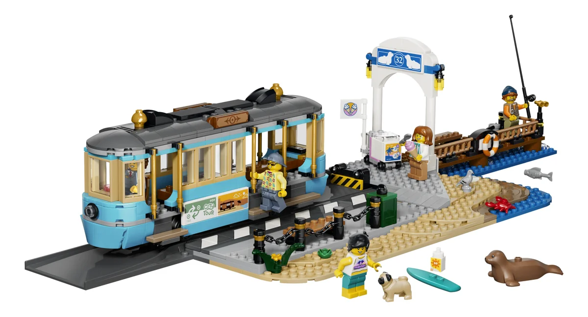 LEGO City Classic Beach Streetcar 60506, a pale blue streetcar on a short track next to a beach station with minifigures, a seal and a surfboard