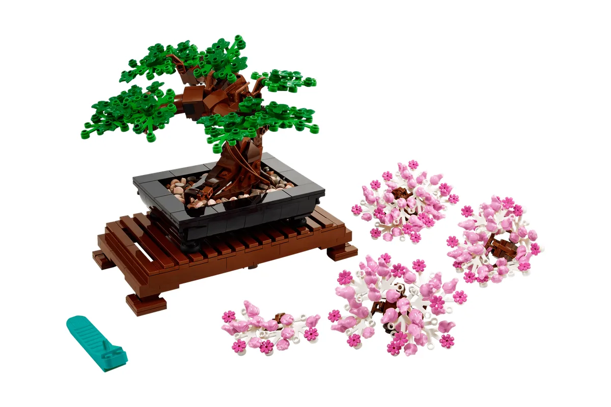 LEGO Icons Bonsai Tree 10281 with its brown tray, green foliage and a separate set of pink blossom pieces