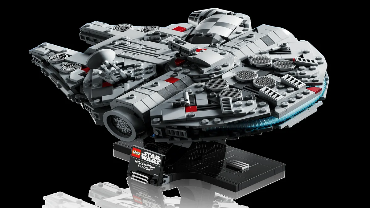 LEGO Star Wars midi-scale Millennium Falcon 75375 on its black display stand against a dark background