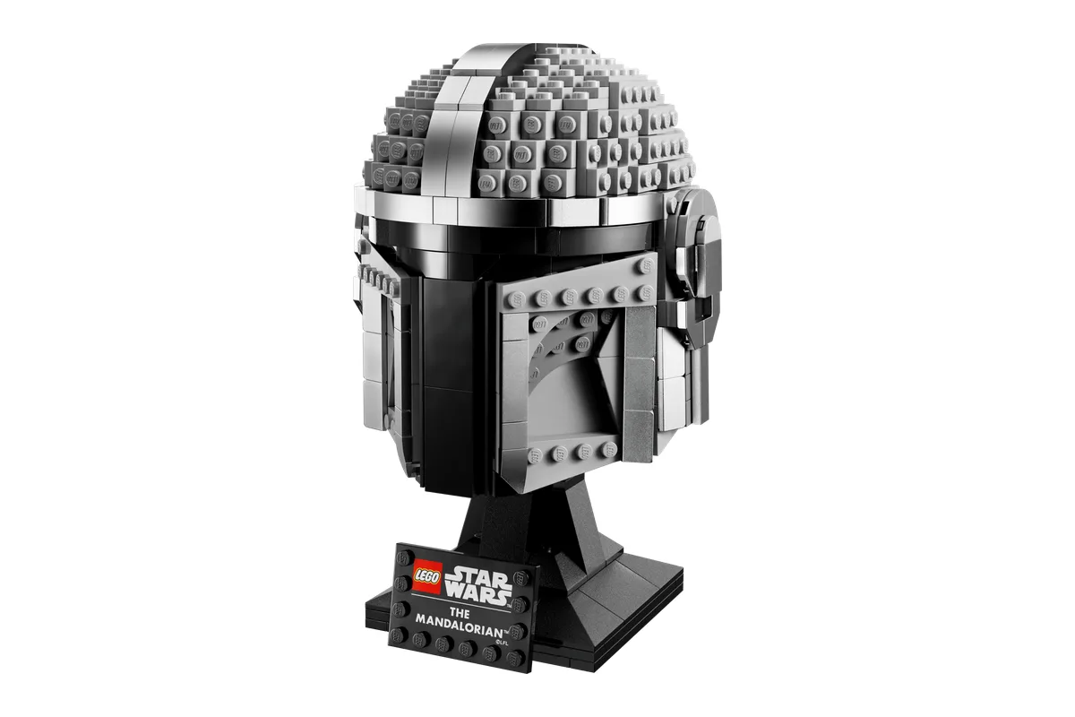 LEGO Star Wars The Mandalorian Helmet 75328, silver with a black visor, on a display stand with a nameplate