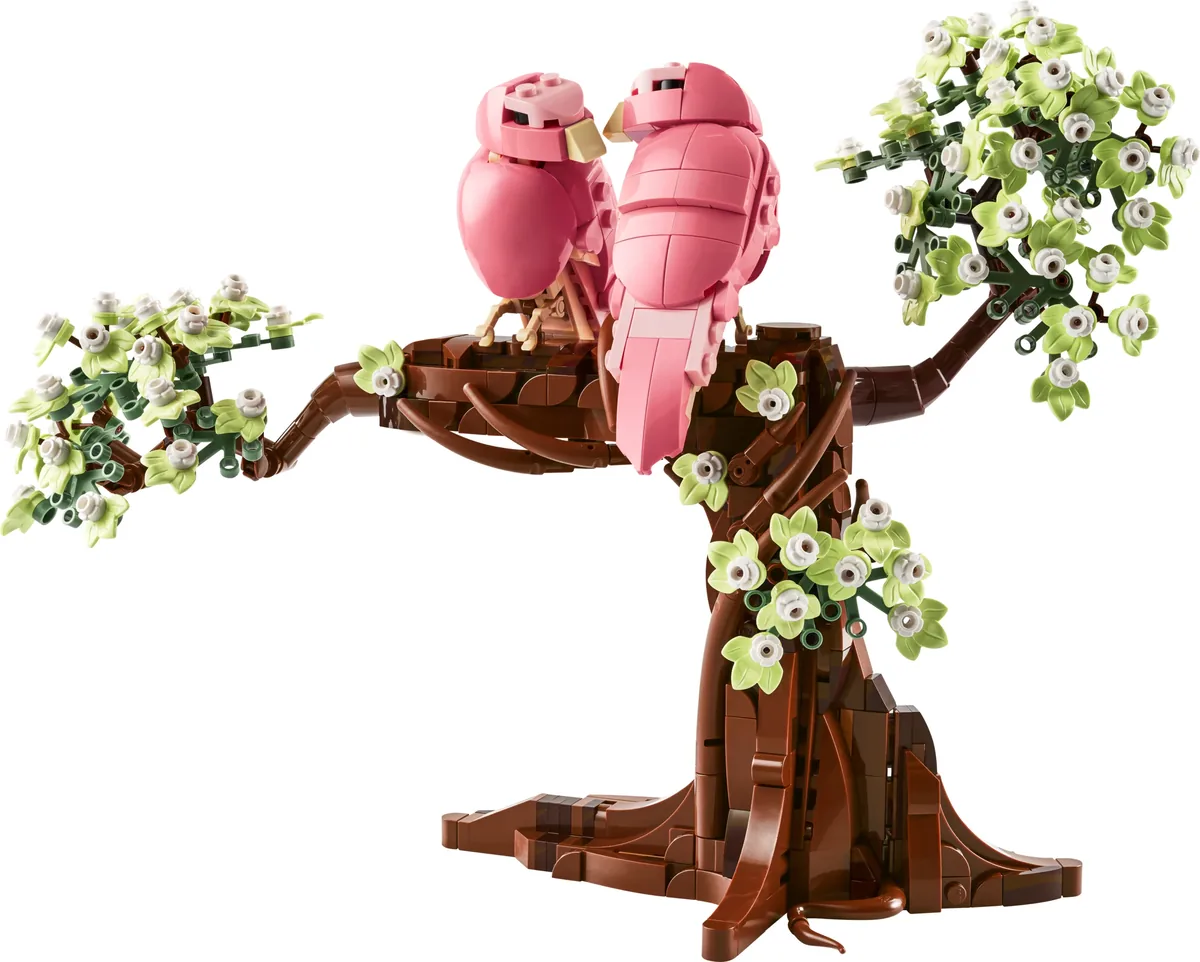 LEGO Ideas Love Birds 21365: two pink brick-built birds on a brown branch with pale green blossom, on a white background
