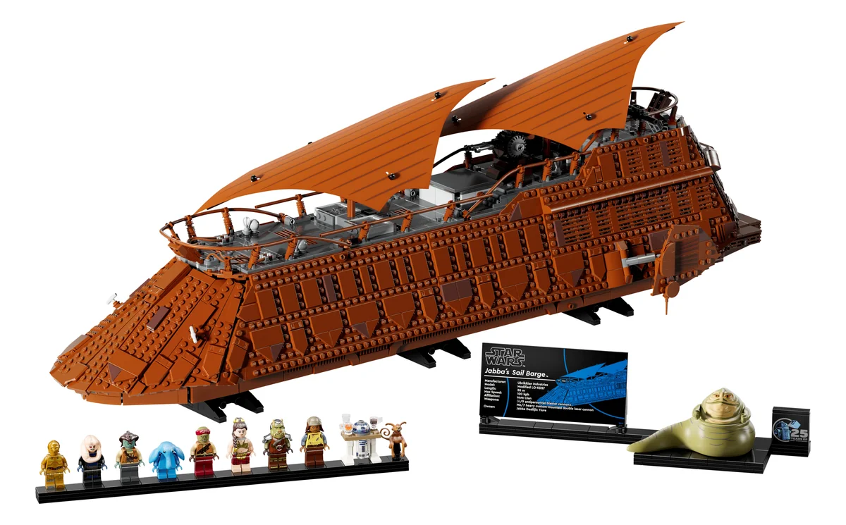 LEGO Star Wars Jabba's Sail Barge 75397, a long brown brick-built sail barge with tan sails, a display stand and a row of minifigures in front