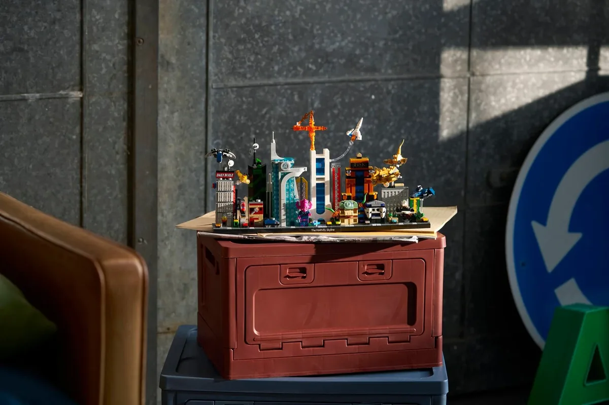 LEGO Marvel The Marvel Skyline 67006: a long, low skyline model on a red storage crate against a concrete wall