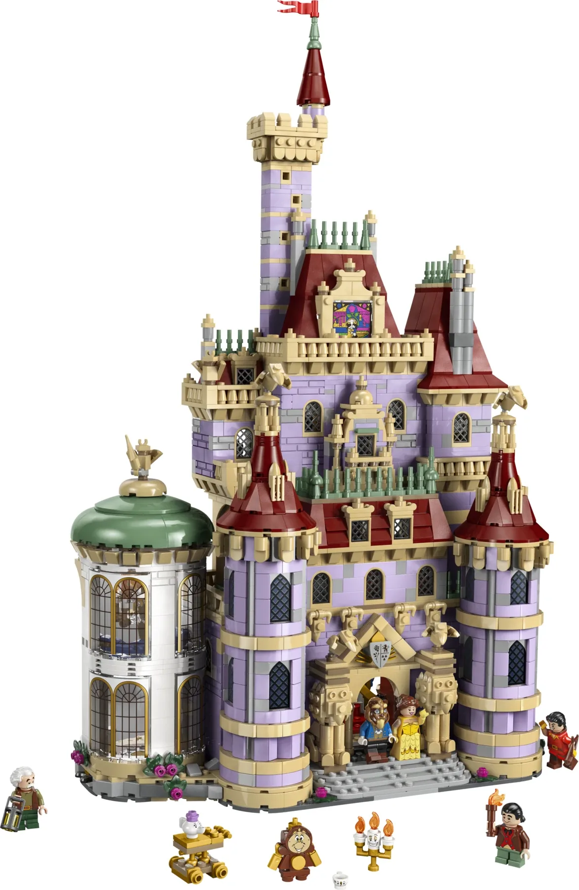 A woman at a table reaching for the tower of the LEGO Beauty and the Beast Castle 43263, with minifigures standing beside the model