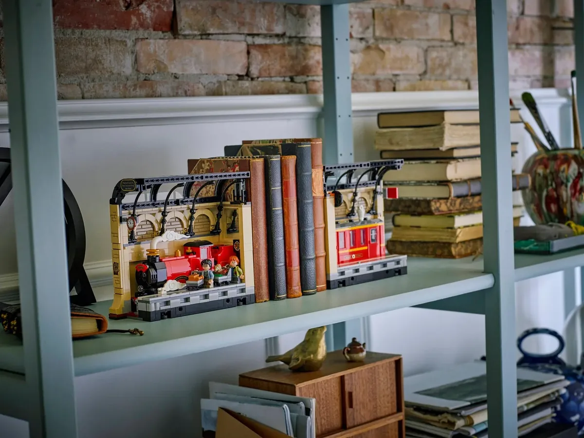 LEGO Harry Potter Book Nook Hogwarts Express 76450 split into two ends with books between, on a grey shelf before a brick wall