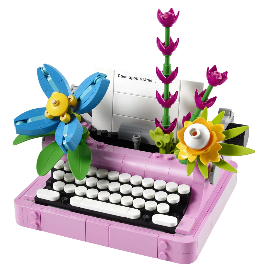 LEGO Creator 3-in-1 Typewriter with Flowers 31169, a pink typewriter with a sheet of paper in the roller and colorful brick flowers