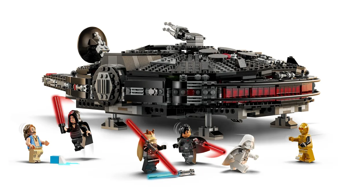 The LEGO Dark Falcon 75389, a black Millennium Falcon with red trim, with Jar Jar, Vader, C-3PO and other minifigures around it