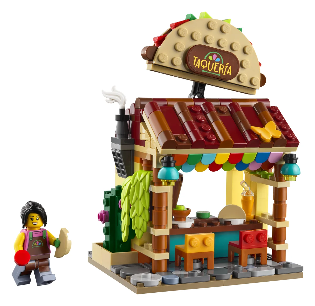 LEGO Restaurants of the World: Mexico 40907, a taqueria stall with a giant taco sign on the roof, colorful bunting, two chairs and a minifigure holding a taco