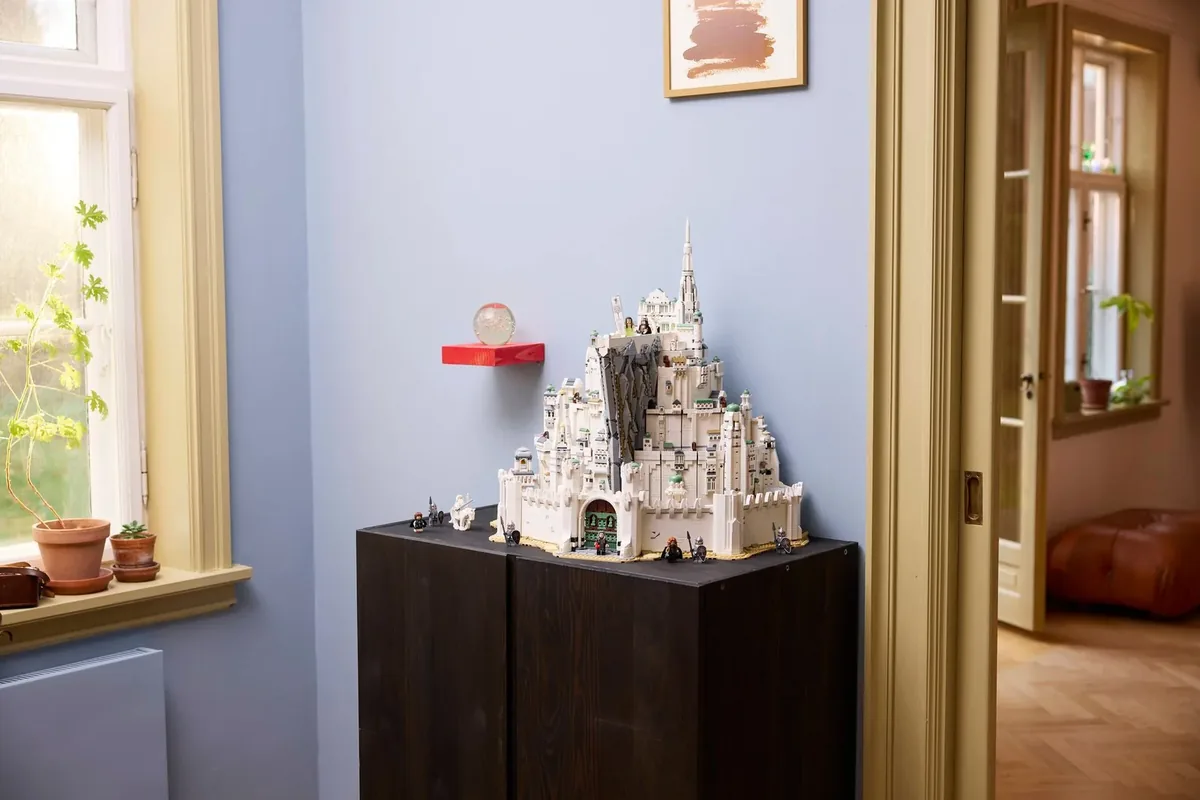 LEGO Lord of the Rings Minas Tirith 11377: the white seven-level city on a dark wooden cabinet against a blue wall