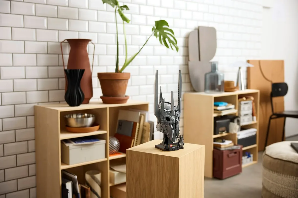 LEGO Lord of the Rings Sauron's Helmet 11373 on a wooden plinth in front of a white tile wall