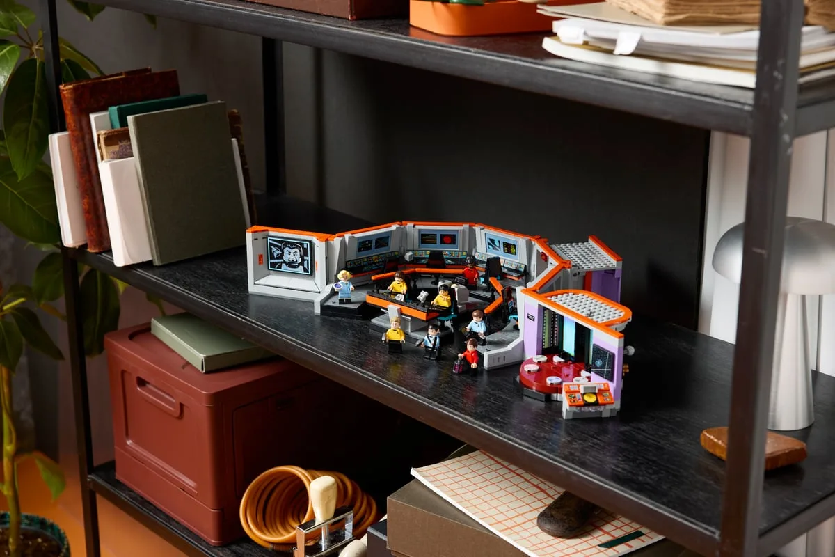 LEGO Star Trek Bridge 11385 on a black metal shelf beside books and a red box