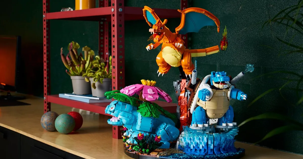 LEGO Pokémon Venusaur, Charizard and Blastoise 72153 on its joined base on a wooden sideboard, red shelves and plants behind