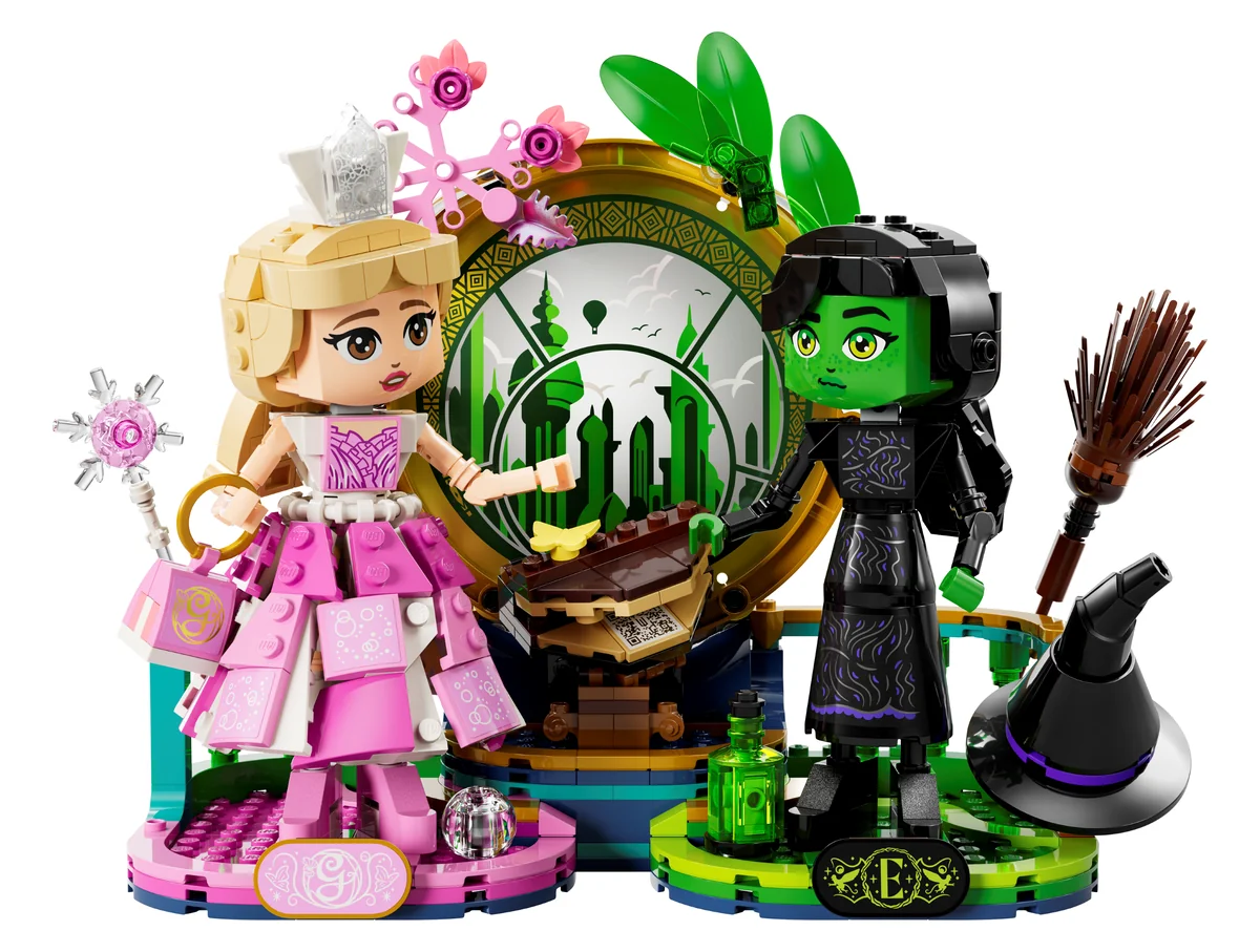 LEGO Wicked Elphaba & Glinda Figures 75682, a brick-built Glinda in a pink dress and Elphaba in black with a broom, on a display base with an emerald ring between them