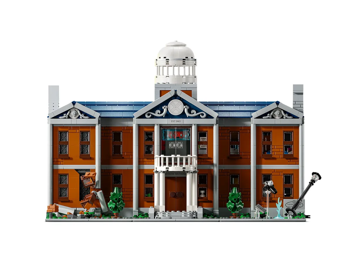 The LEGO X-Mansion 76294 seen from the front on a white background, a red-brick building with a white columned porch, a domed tower and a damaged left wing