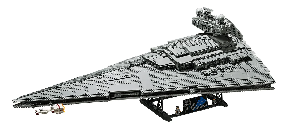 LEGO Star Wars UCS Imperial Star Destroyer 75252, a long grey wedge-shaped starship on a black display stand with two small minifigures